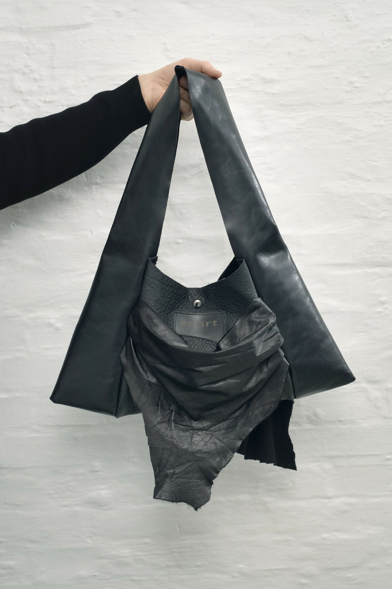 draped raw leather handbag Sahrt